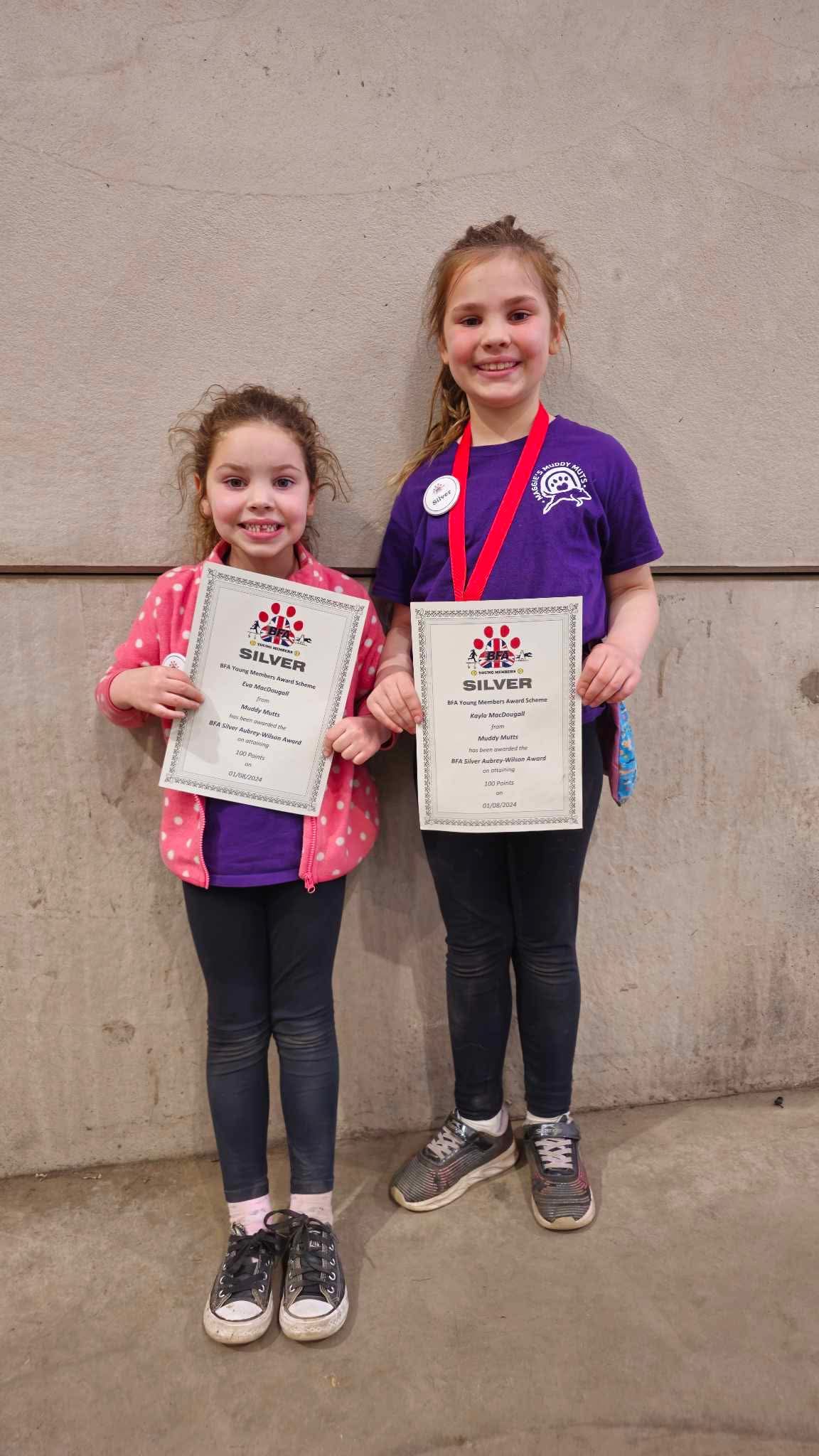 Two girls holding BFA Silver award certificates