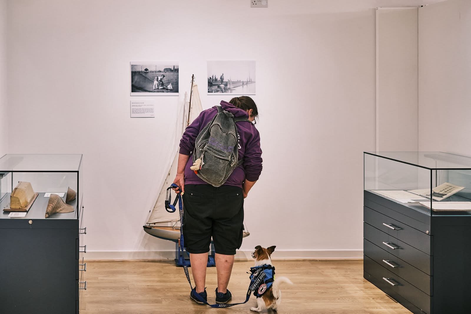 Maggie and therapy dog at a museum